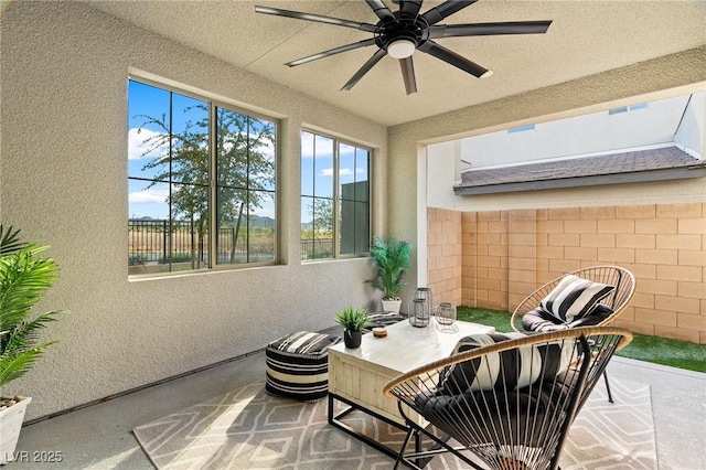 view of patio featuring fence and a ceiling fan