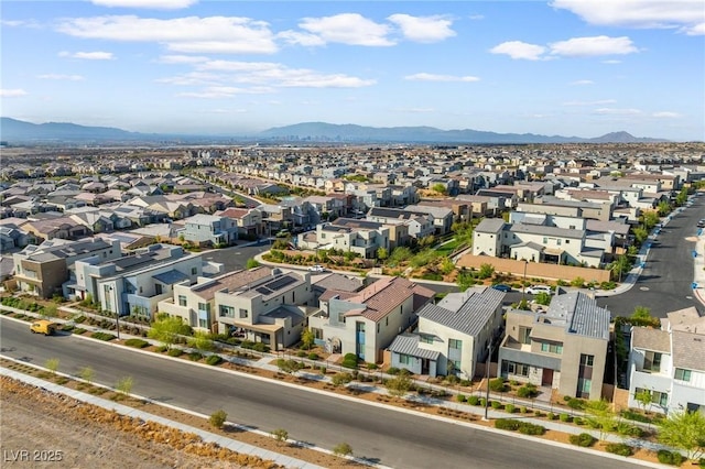drone / aerial view featuring a residential view and a mountain view