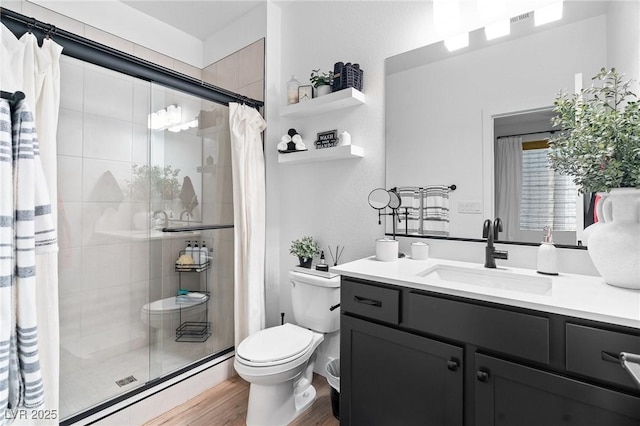 full bath featuring a shower stall, toilet, and wood finished floors