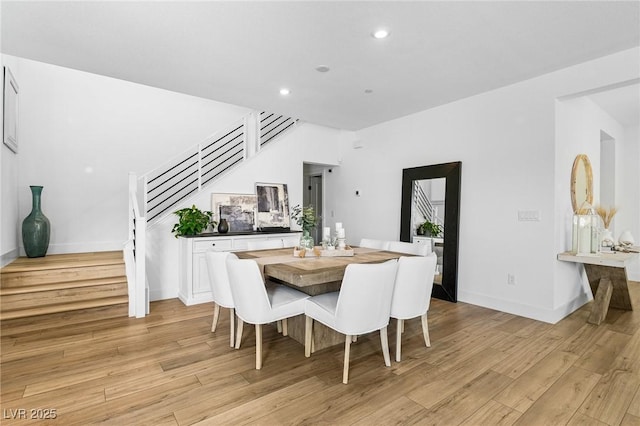 dining room with stairway, recessed lighting, baseboards, and light wood-type flooring