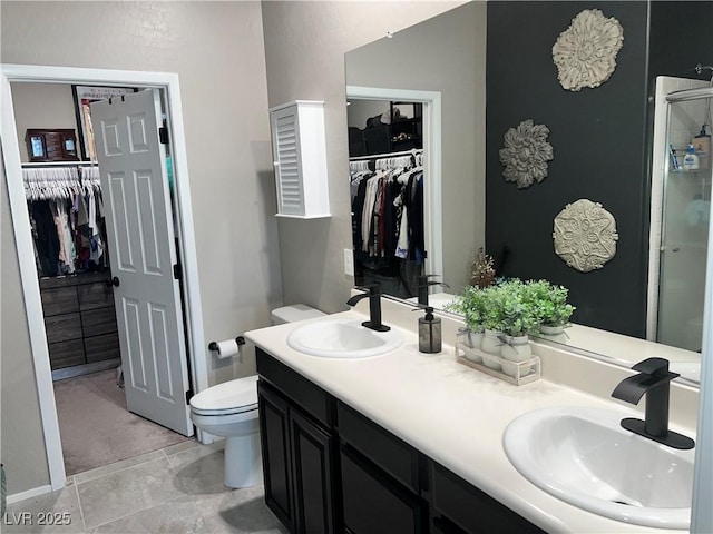 2585 Amazing Meadows Ave Unit 1007, North Las Vegas, NV 89031 - bathroom featuring a sink, a walk in closet, and toilet