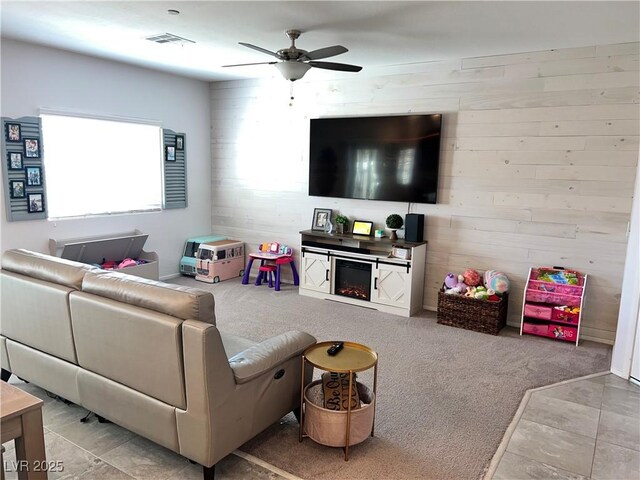 2585 Amazing Meadows Ave Unit 1007, North Las Vegas, NV 89031 - living room featuring a ceiling fan, wood walls, visible vents, and carpet