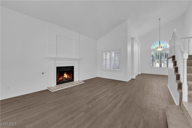 2808 Deep Water Cir, Las Vegas, NV 89117 - unfurnished living room featuring wood finished floors, stairs, a chandelier, healthy amount of natural light, and high vaulted ceiling