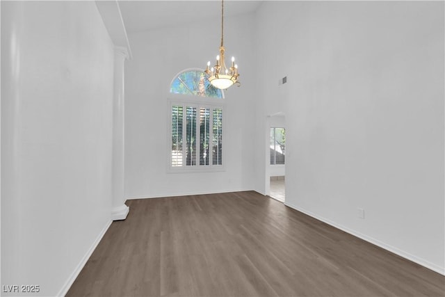 2808 Deep Water Cir, Las Vegas, NV 89117 - unfurnished dining area with a chandelier, wood finished floors, baseboards, and a high ceiling