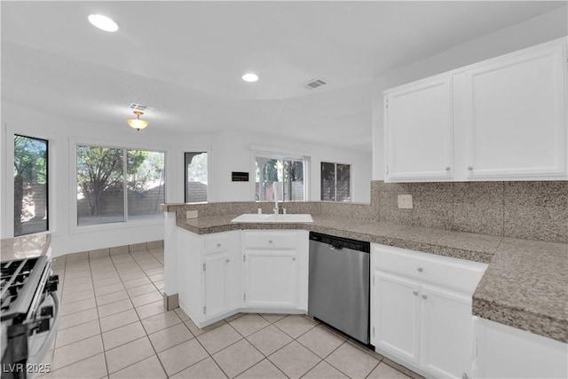 2808 Deep Water Cir, Las Vegas, NV 89117 - kitchen with stainless steel appliances, a sink, white cabinets, tile counters, and a peninsula