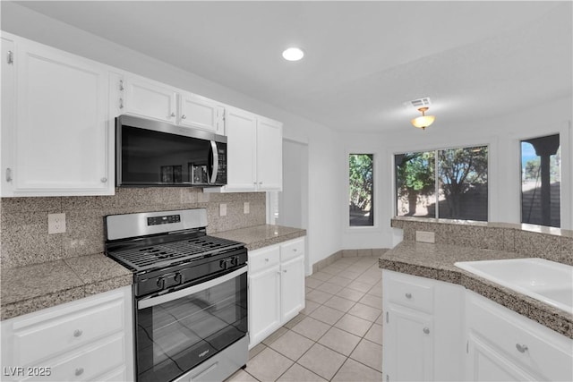 2808 Deep Water Cir, Las Vegas, NV 89117 - kitchen with appliances with stainless steel finishes, tile counters, decorative backsplash, light tile patterned flooring, and recessed lighting