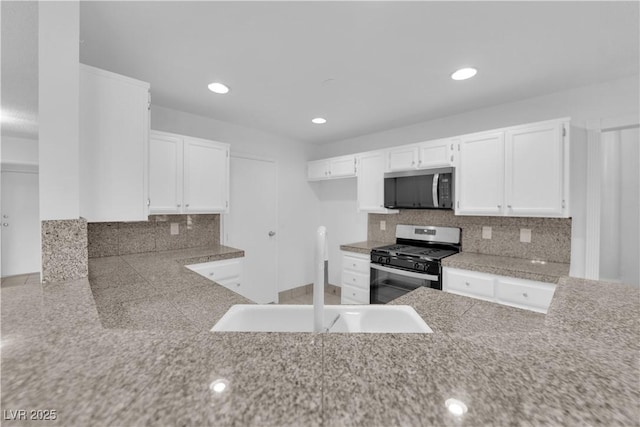 2808 Deep Water Cir, Las Vegas, NV 89117 - kitchen with stainless steel appliances, a sink, white cabinets, tasteful backsplash, and recessed lighting