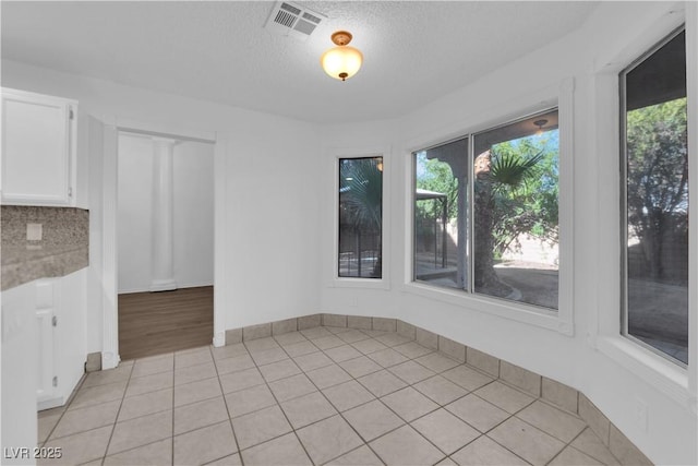 2808 Deep Water Cir, Las Vegas, NV 89117 - unfurnished dining area featuring light tile patterned floors and a textured ceiling