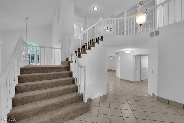 2808 Deep Water Cir, Las Vegas, NV 89117 - stairway featuring a ceiling fan, a towering ceiling, tile patterned floors, and baseboards