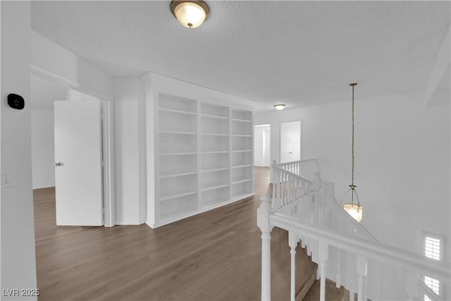2808 Deep Water Cir, Las Vegas, NV 89117 - hallway featuring an upstairs landing, wood finished floors, built in shelves, and a textured ceiling