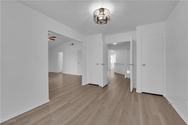 2808 Deep Water Cir, Las Vegas, NV 89117 - unfurnished room featuring light wood-type flooring, a textured ceiling, ceiling fan, and baseboards