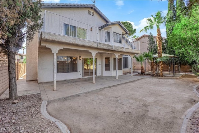 2808 Deep Water Cir, Las Vegas, NV 89117 - rear view of house with a balcony, a patio area, and stucco siding