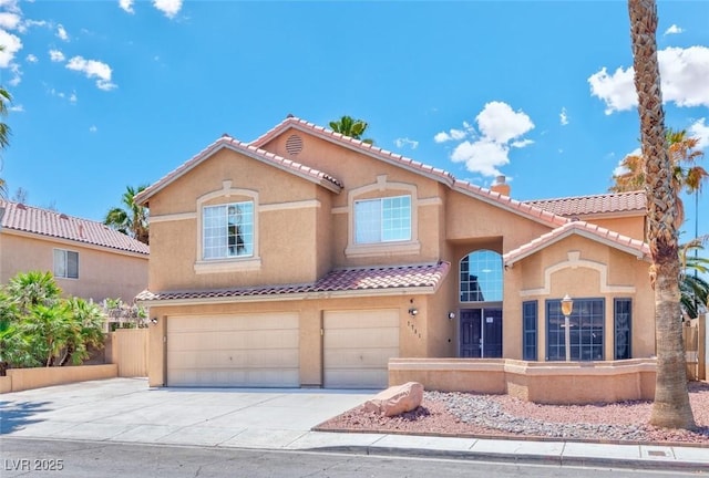 7751 Locke Haven Dr, Las Vegas, NV 89123 - mediterranean / spanish-style house featuring fence, an attached garage, a tile roof, stucco siding, and driveway