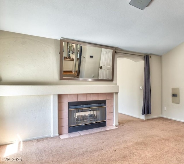 7751 Locke Haven Dr, Las Vegas, NV 89123 - unfurnished living room with carpet floors, a tile fireplace, baseboards, and a textured ceiling