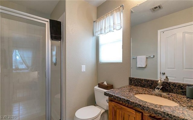 7751 Locke Haven Dr, Las Vegas, NV 89123 - full bathroom featuring a stall shower, toilet, vanity, and a textured wall