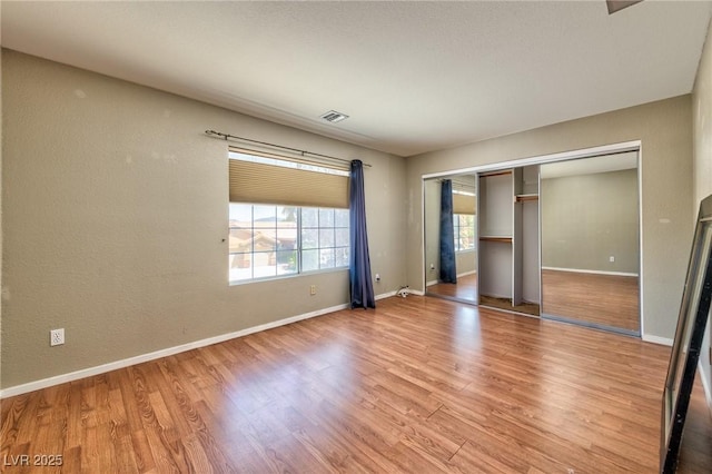 7751 Locke Haven Dr, Las Vegas, NV 89123 - unfurnished bedroom with light wood finished floors, baseboards, and a closet