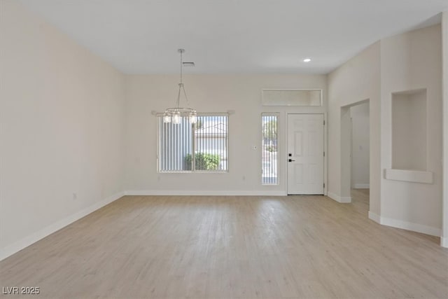 entryway featuring light wood-style floors, baseboards, recessed lighting, and a notable chandelier