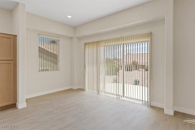 unfurnished room featuring light wood-style floors, recessed lighting, and baseboards