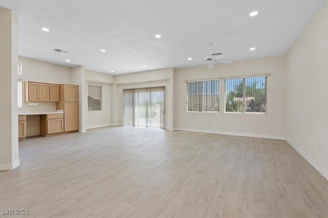 unfurnished living room featuring baseboards, light wood-type flooring, recessed lighting, and visible vents