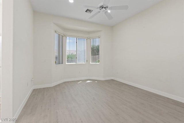unfurnished room with ceiling fan, recessed lighting, baseboards, wood finished floors, and visible vents