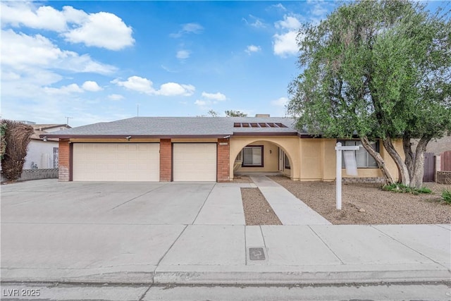 1913 Piccolo Way, Las Vegas, NV 89146 - view of front of property featuring driveway, an attached garage, roof mounted solar panels, and stucco siding