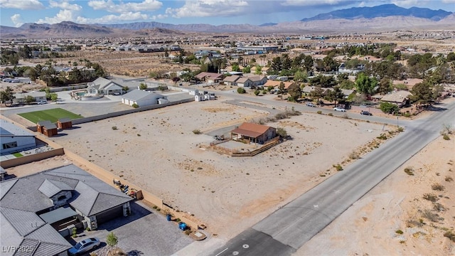 birds eye view of property featuring a residential view, view of desert, and a mountain view
