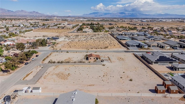 aerial view with a residential view, view of desert, and a mountain view