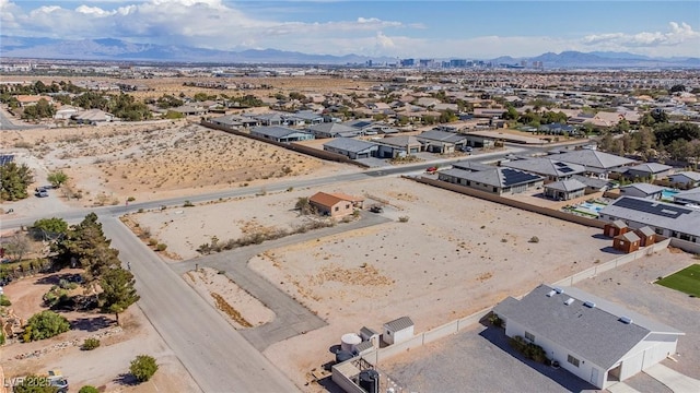 aerial view with a mountain view, view of desert, and a residential view