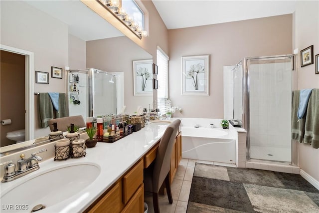 bathroom with double vanity, a bath, a shower stall, and a sink