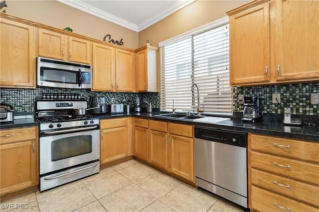kitchen featuring a sink, light tile patterned flooring, decorative backsplash, and appliances with stainless steel finishes