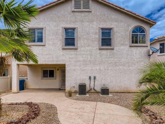 back of house with a patio, central AC unit, stucco siding, and fence