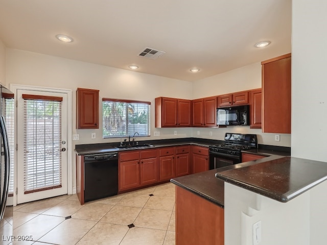 kitchen with a sink, a peninsula, recessed lighting, visible vents, and black appliances