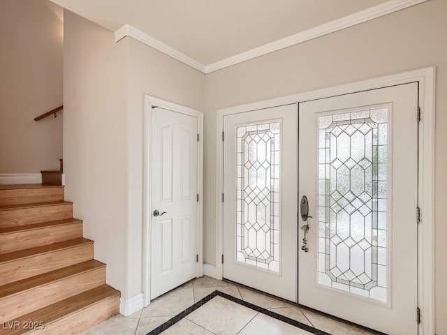 entryway with stairs, baseboards, crown molding, and light tile patterned floors