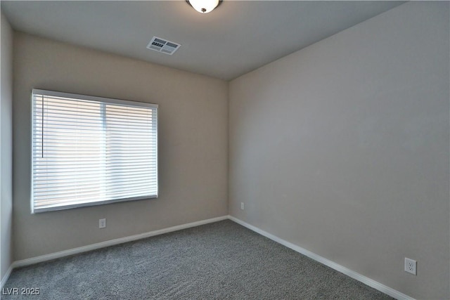 empty room featuring carpet flooring, baseboards, and visible vents