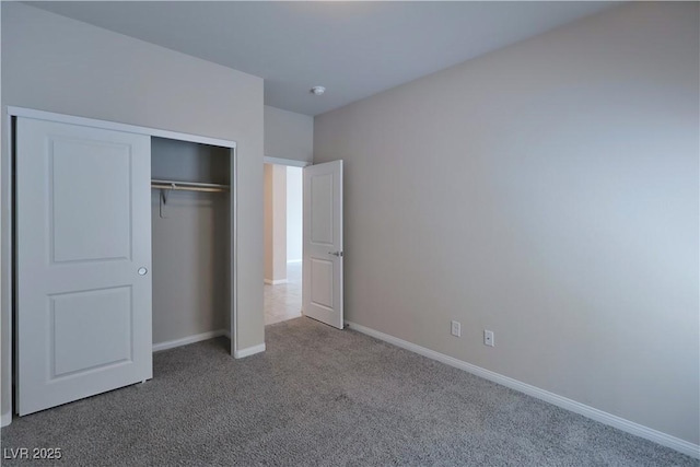 unfurnished bedroom featuring a closet, carpet, and baseboards