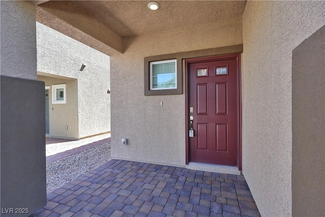 doorway to property with stucco siding