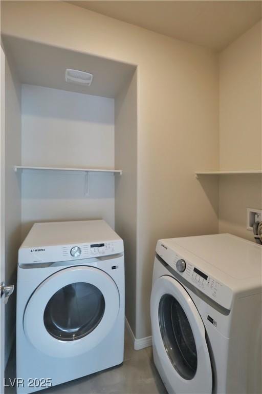 clothes washing area with laundry area and washer and dryer