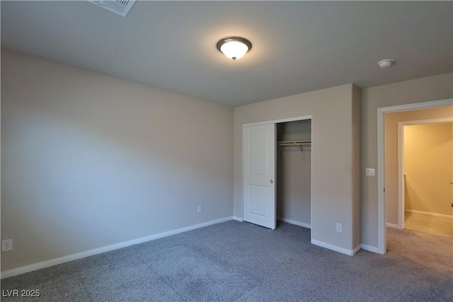 unfurnished bedroom with visible vents, carpet, baseboards, and a closet