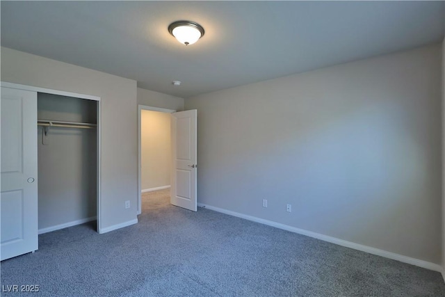 unfurnished bedroom with baseboards, carpet flooring, and a closet