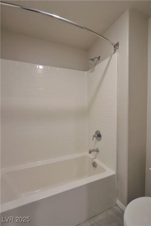 full bathroom with washtub / shower combination, baseboards, and toilet