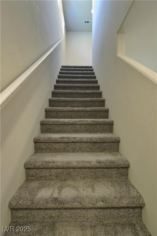 staircase featuring visible vents