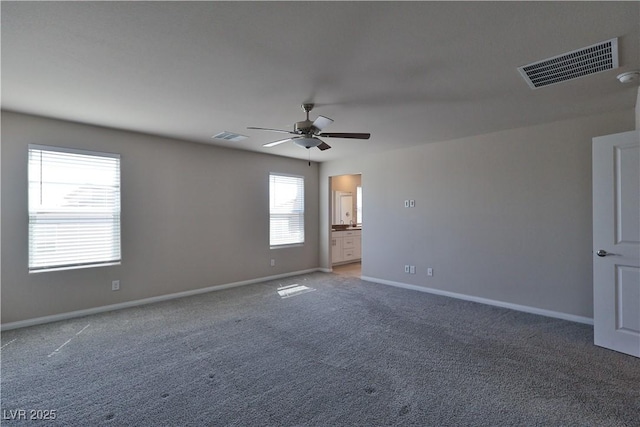 unfurnished room featuring visible vents, a ceiling fan, baseboards, and light carpet