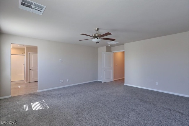 carpeted empty room with ceiling fan, visible vents, and baseboards