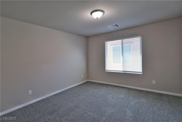 carpeted empty room featuring baseboards and visible vents