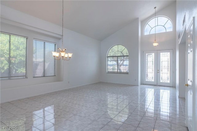 787 Craigmark Ct, Henderson, NV 89002 - foyer entrance with healthy amount of natural light, a chandelier, high vaulted ceiling, french doors, and light tile patterned floors