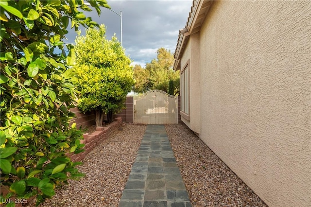 787 Craigmark Ct, Henderson, NV 89002 - view of side of home with stucco siding and a gate