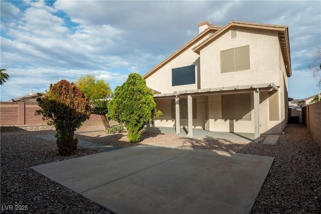 787 Craigmark Ct, Henderson, NV 89002 - back of property featuring a patio area, stucco siding, a fenced backyard, and a chimney