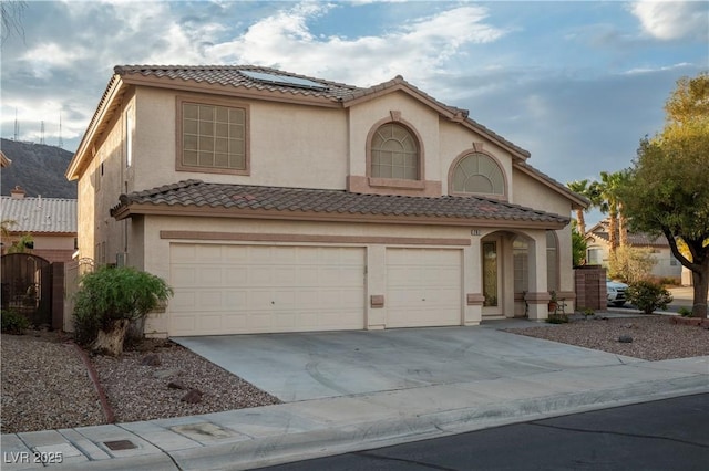 787 Craigmark Ct, Henderson, NV 89002 - mediterranean / spanish-style house with solar panels, a garage, driveway, stucco siding, and a tile roof