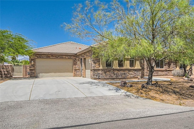 3910 Internet Ave, North Las Vegas, NV 89031 - view of front of property with a tile roof, an attached garage, stone siding, driveway, and a gate