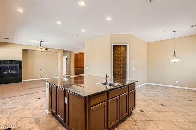 3910 Internet Ave, North Las Vegas, NV 89031 - kitchen with a sink, ceiling fan, a kitchen island with sink, light tile patterned floors, and recessed lighting